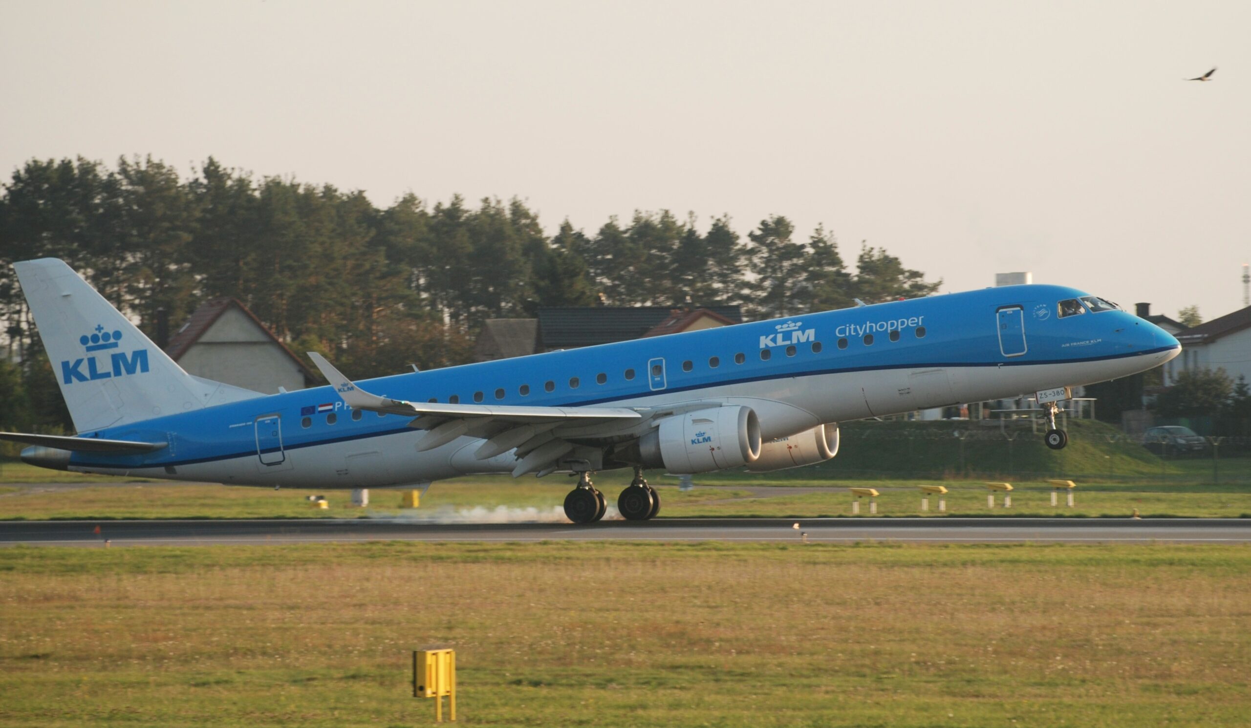 a blue and white airplane is on the runway